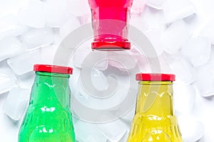 Fruit drinks in colorful plastic bottles with ice top view mock-up