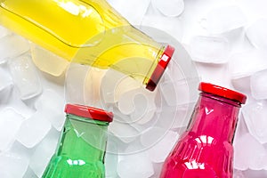 Fruit drinks in colorful plastic bottles with ice top view mock-up