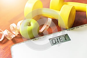 Fruit, dumbbell and scale, fat burn and weight loss concept