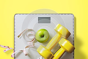 Fruit, dumbbell and scale, fat burn and weight loss