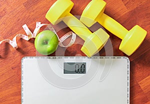 Fruit, dumbbell and scale, fat burn and weight loss concept