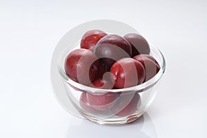 Fruit: Fresh Red Plumes on White Background