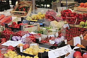 Fruit and fresh vegetables, in boxes on market stall in Italy