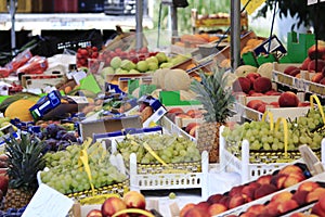 Fruit and fresh vegetables, in boxes on market stall in Italy