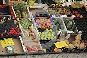 Fruit and fresh vegetables, in boxes on market stall in Italy