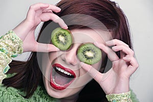 Fruit funny woman holding kiwi