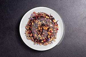 Fruit garden tea on white plate on dark backgroung