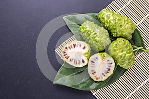 Fruit of Great morinda (Noni) or Morinda citrifolia tree and gre