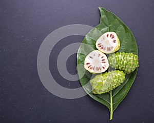 Fruit of Great morinda (Noni) or Morinda citrifolia tree and gre