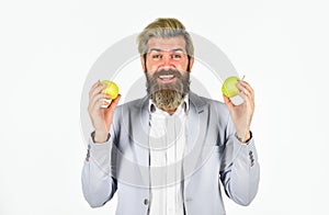 Fruit harvest. Successful businessman holding an apple. Business lunch. Education business. Cheerful smiling man with