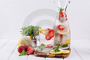 Fruit and herb infused water. Cold refreshing vitamin detox water.