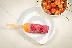 Fruit ice and berries of sweet cherry/fruit ice and berries of sweet cherry on a white marble background. Top view