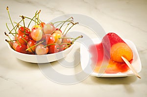 Fruit ice cream and bowl with sweet cherry/fruit ice cream and bowl with sweet cherry on a white marble background. Selective