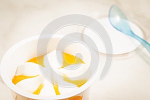 Fruit ice cream in a glass and a spoon/fruit ice cream in a glass and blue spoon, selective focus