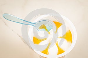 Fruit ice cream in a glass and spoon/fruit ice cream in glass and spoon on a white background, top view