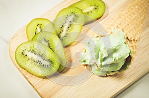 Fruit ice cream from a kiwi on a wooden tray/fruit ice cream from a kiwi on a wooden tray, top view