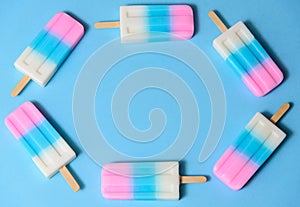 Fruit Ice cream stick , popsicle ,  with copyspace on blue and pink pastel background or texture