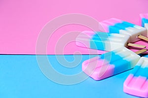 Fruit Ice cream stick , popsicle , ice pop or freezer pop with copyspace on blue and pink pastel background or texture