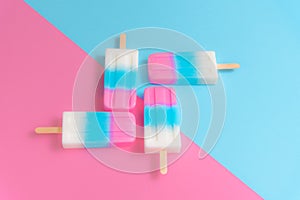 Fruit Ice cream stick , popsicle , ice pop or freezer pop with copyspace on blue and pink pastel background or texture