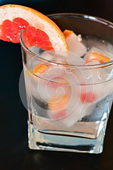 Fruit in ice cubes in water