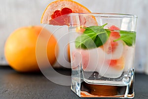 Fruit in ice cubes in water