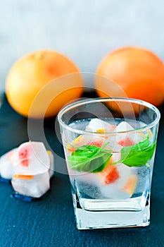 Fruit in ice cubes in water