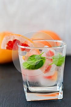 Fruit in ice cubes in water