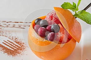 Fruit ice. Fruit dessert with many fruits. Orange, strawberry, c