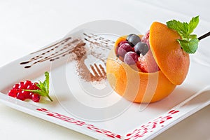 Fruit ice. Fruit dessert with many fruits. Orange, strawberry, c