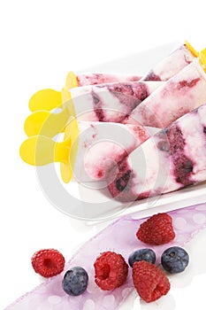 Fruit ice lolly with fresh fruit on white background.