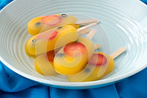 Fruit Ice Pops in a Blue Bowl on Blue Background