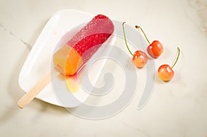 Fruit ice and sweet cherry in a white bowl/fruit ice and sweet cherry in a white bowl. Top view