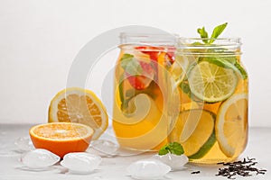 Fruit ice tea and ginger herbal ice tea with mint in a glass jar