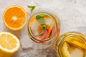 Fruit ice tea and ginger herbal ice tea with mint in a glass jar