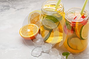 Fruit ice tea and ginger herbal ice tea with mint in a glass jar