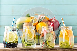 Fruit infused detox water in glass jars and ingredients photo