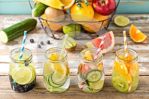 Fruit infused detox water in glass jars and ingredients photo