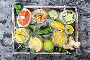 Fruit infused detox water in glass jars and ingredients