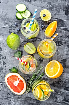 Fruit infused detox water in glass jars and ingredients