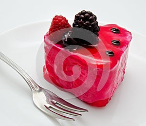 Fruit jelly cake and fork on the plate isolated on a white