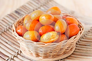 Fruit Jocote (Red, Purple Mombin, Siriguela, Hog Plum, Sineguela, Ciruela Huesito) in wicker basket photo