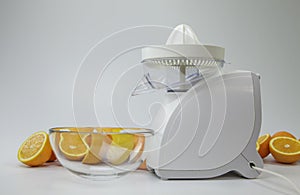 Fruit juicer and halfes of oranges