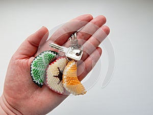 Fruit keychains lies on a woman's palm photo
