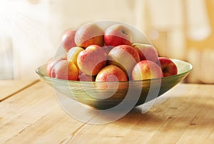 Fruit, kitchen and apples in bowl on table for jelly or applesauce, juice and food for lunch in house. Lens flare