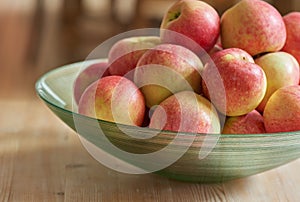 Fruit, kitchen and red apples in bowl on table for nutrition, diet and food for lunch in house. Natural, summer and