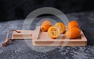 Fruit kumquat against a grey concrete background