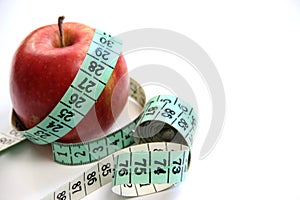 Fruit and measurement tape on the white background