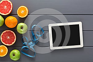 Fruit, measuring tape and blank tablet mockup