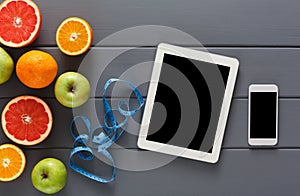 Fruit, measuring tape and blank tablet mockup