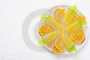 Fruit orange ice lolly and slices of orange